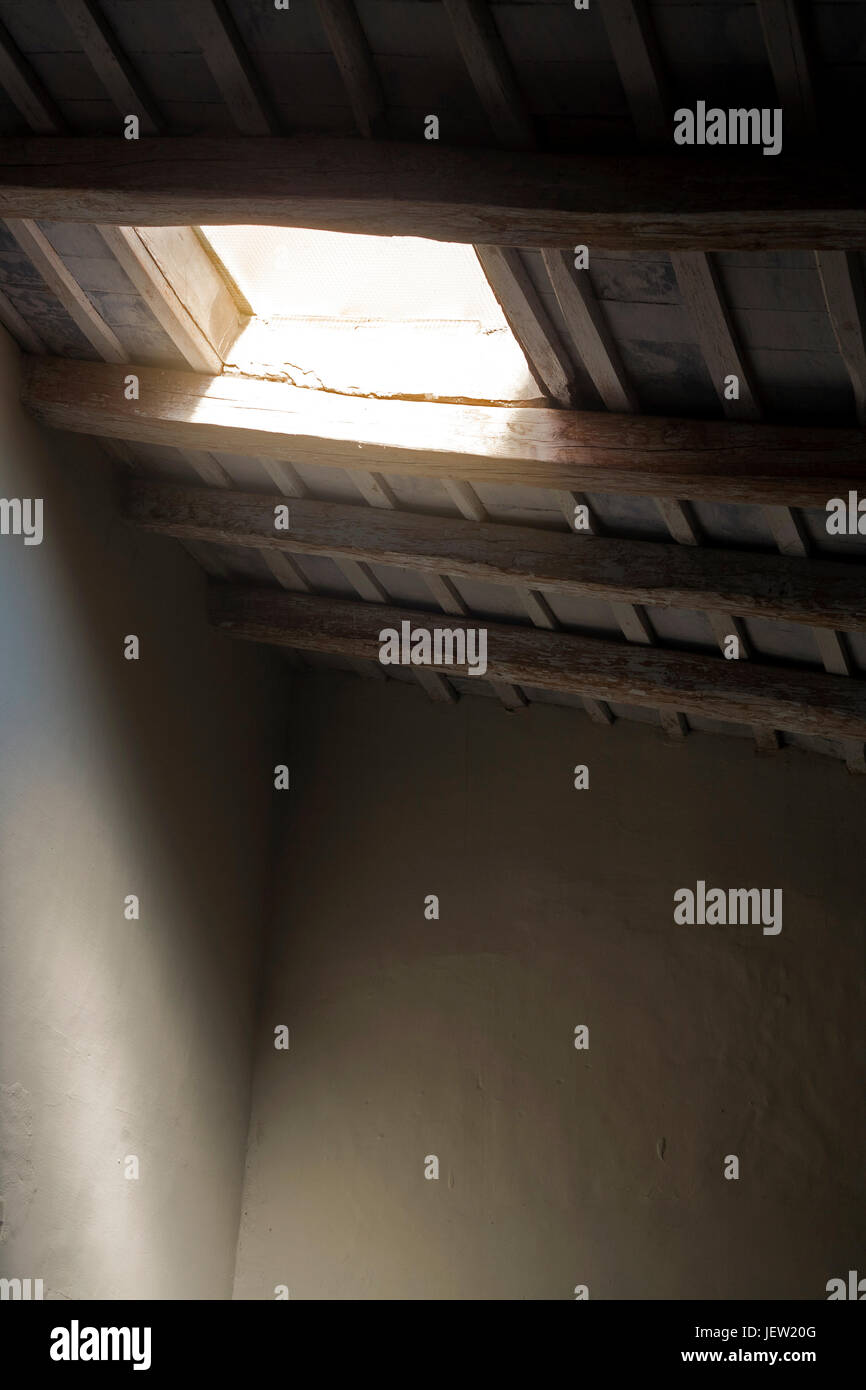 Skylight from an old, rural country house. Sunlight is coming in Stock