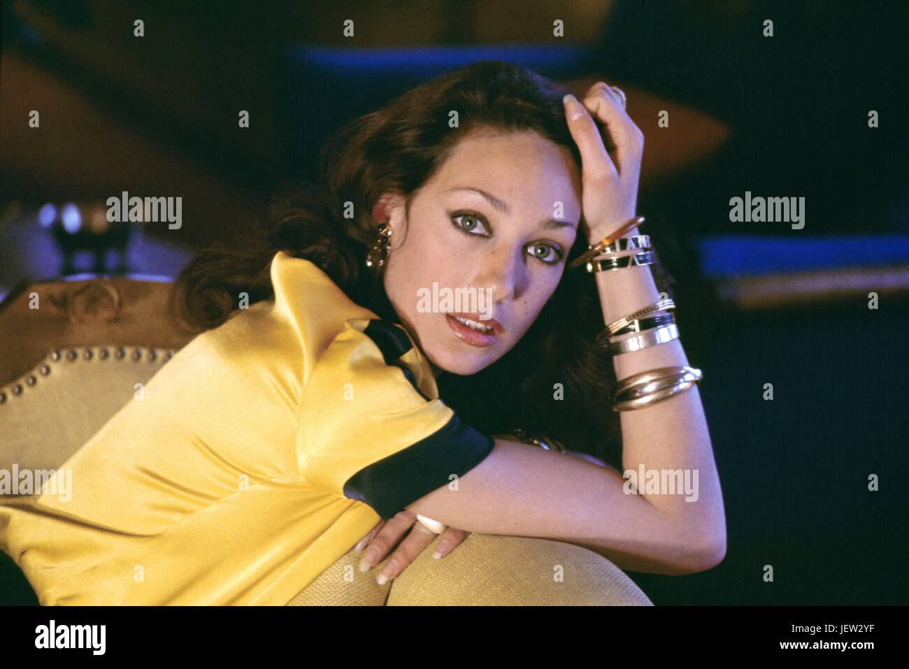 American model Marisa Berenson, posing in a yellow silk pyjamas designed by Valentino. She came a few days at Austrian conductor Herbert von Karajan's chalet in Saint-Moritz.  March 1974 Photo Michael Holtz Stock Photo