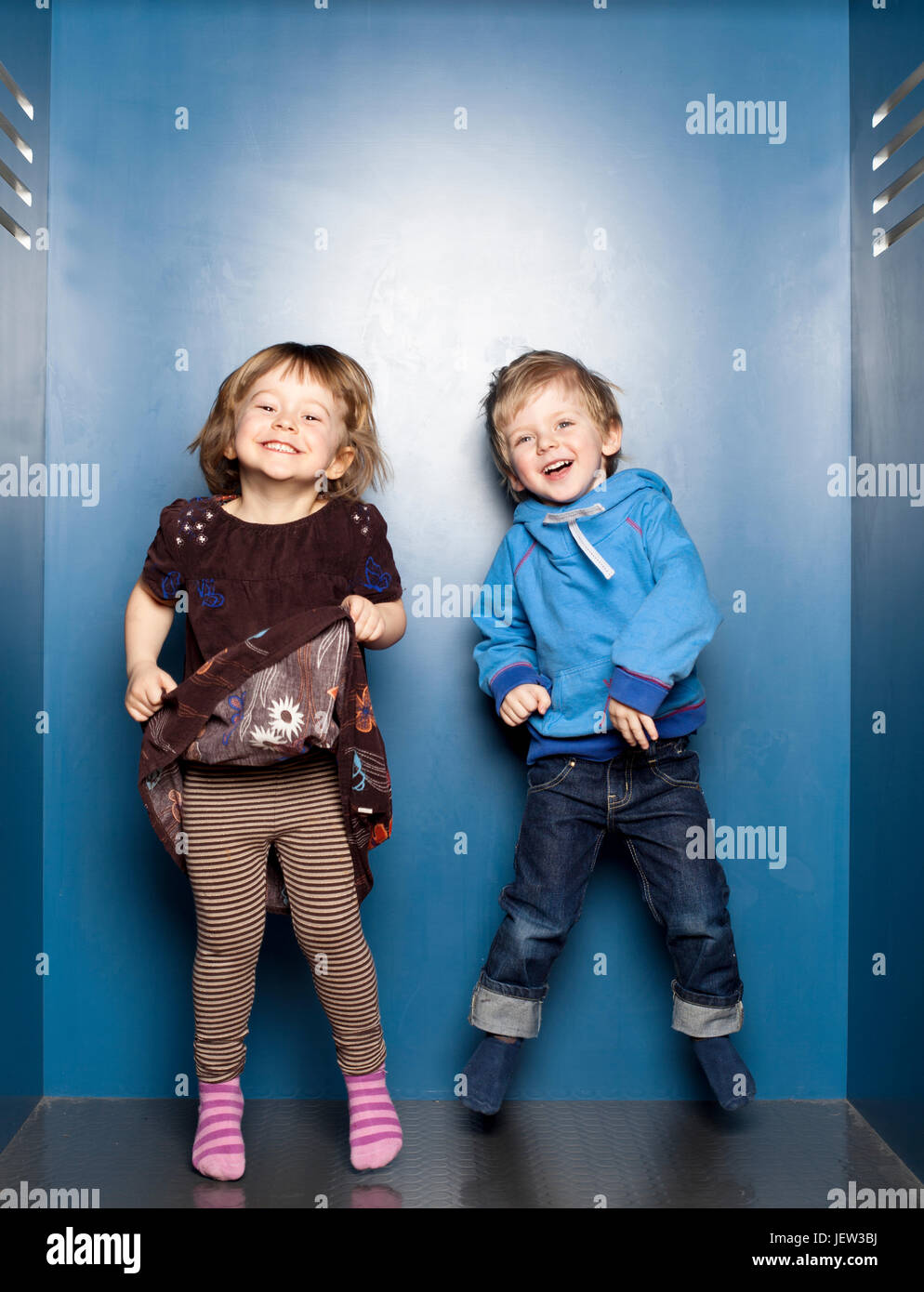 Boy and girl jumping Stock Photo - Alamy