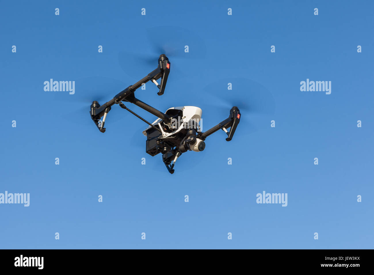 Black quadrocopter is flying high in the sky Stock Photo - Alamy