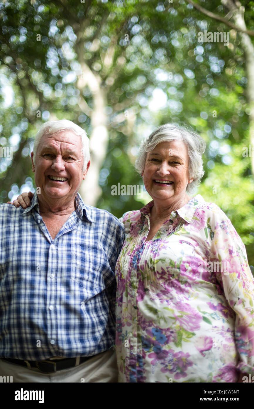 Portrait of happy couple against trees Stock Photo - Alamy
