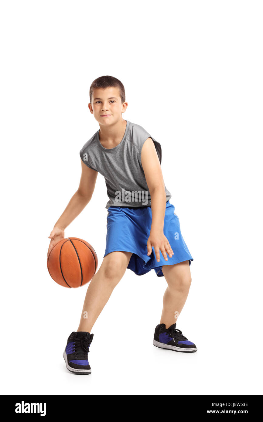 Full length portrait of a kid playing with a basketball isolated