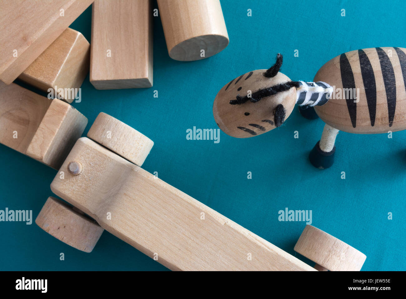 Eco children toys scattered. Wooden blocks, car and zebra on blue background Stock Photo