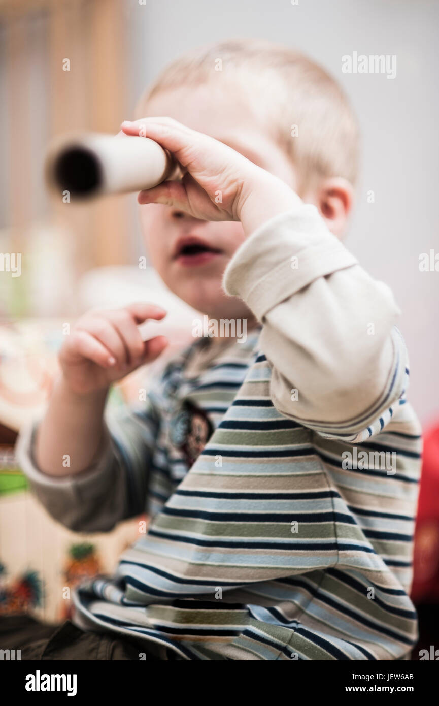 Boy looking through telescope Stock Photo - Alamy