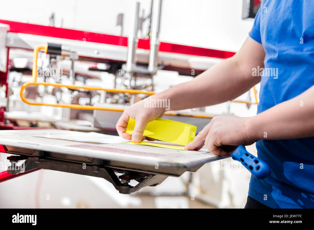 Man preparing material for screen printing in a Serigraphy
