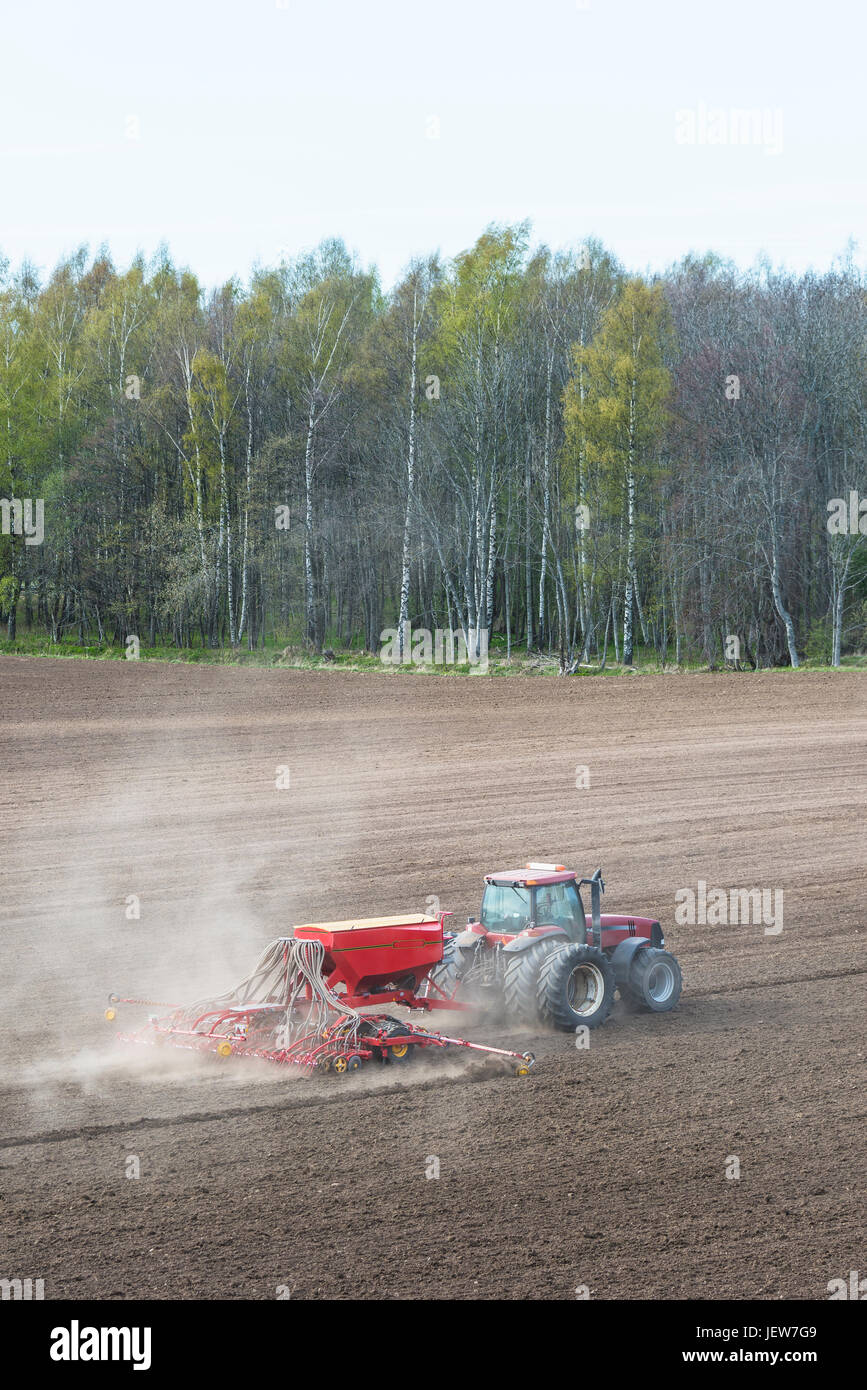 Tractor with plow on field Stock Photo - Alamy
