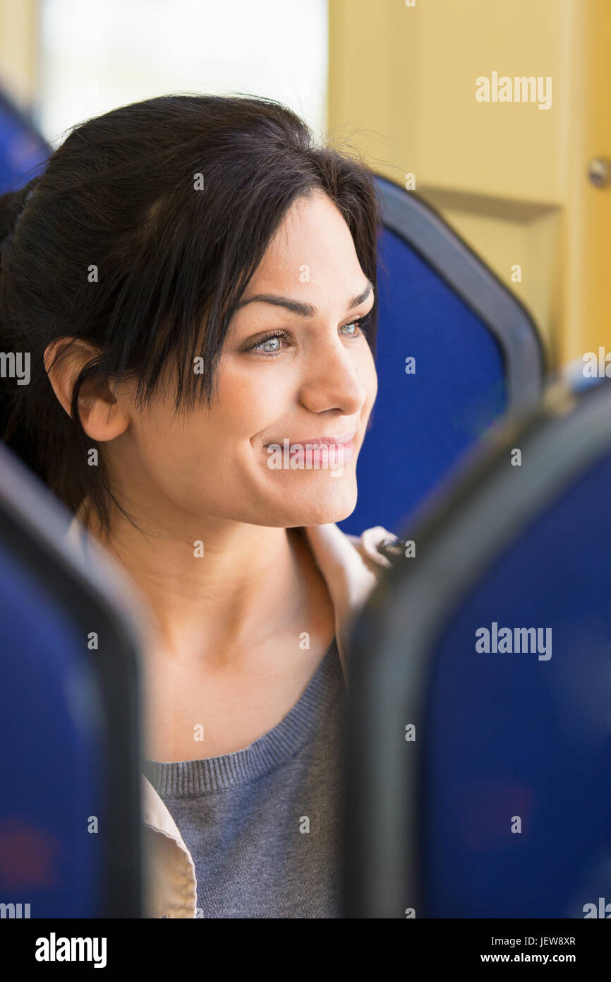 Smiling woman in train Stock Photo - Alamy