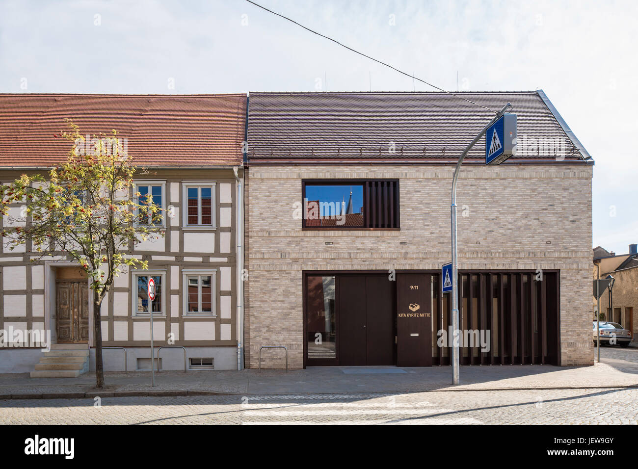 Juxtaposition of old and new. Kindergarten Mitte Kyritz, Kyritz, Germany. Architect: kleyer koblitz letzel freivogel, 2016. Stock Photo