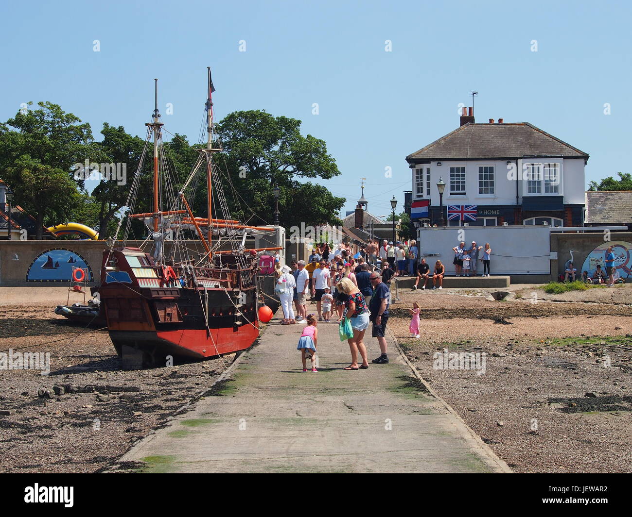 Causeway at Queenborough with replica Galleon ship and the Old House at Home pub in the distance. Stock Photo