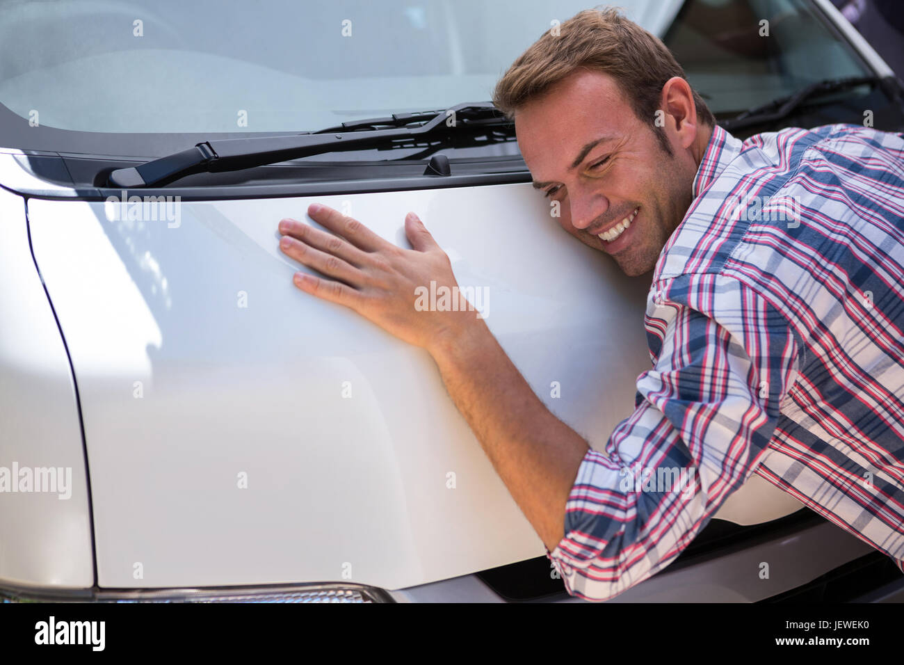 Young man hugging his car Stock Photo Alamy