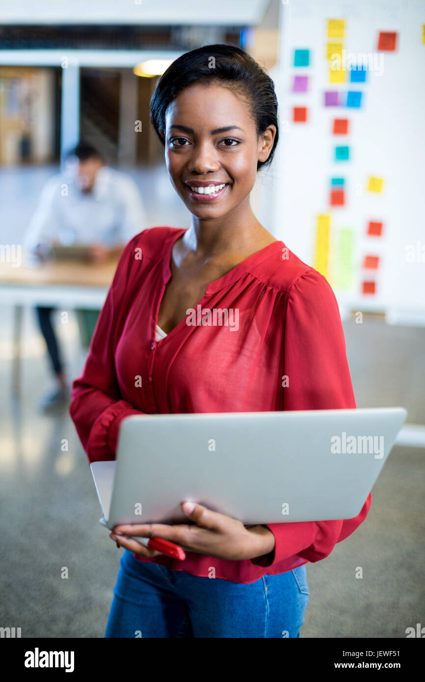 Young woman holding laptop Stock Photo - Alamy