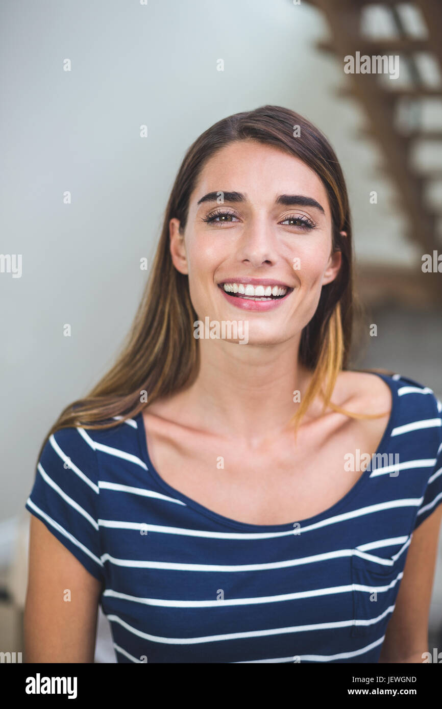 Beautiful woman smiling in living room Stock Photo - Alamy