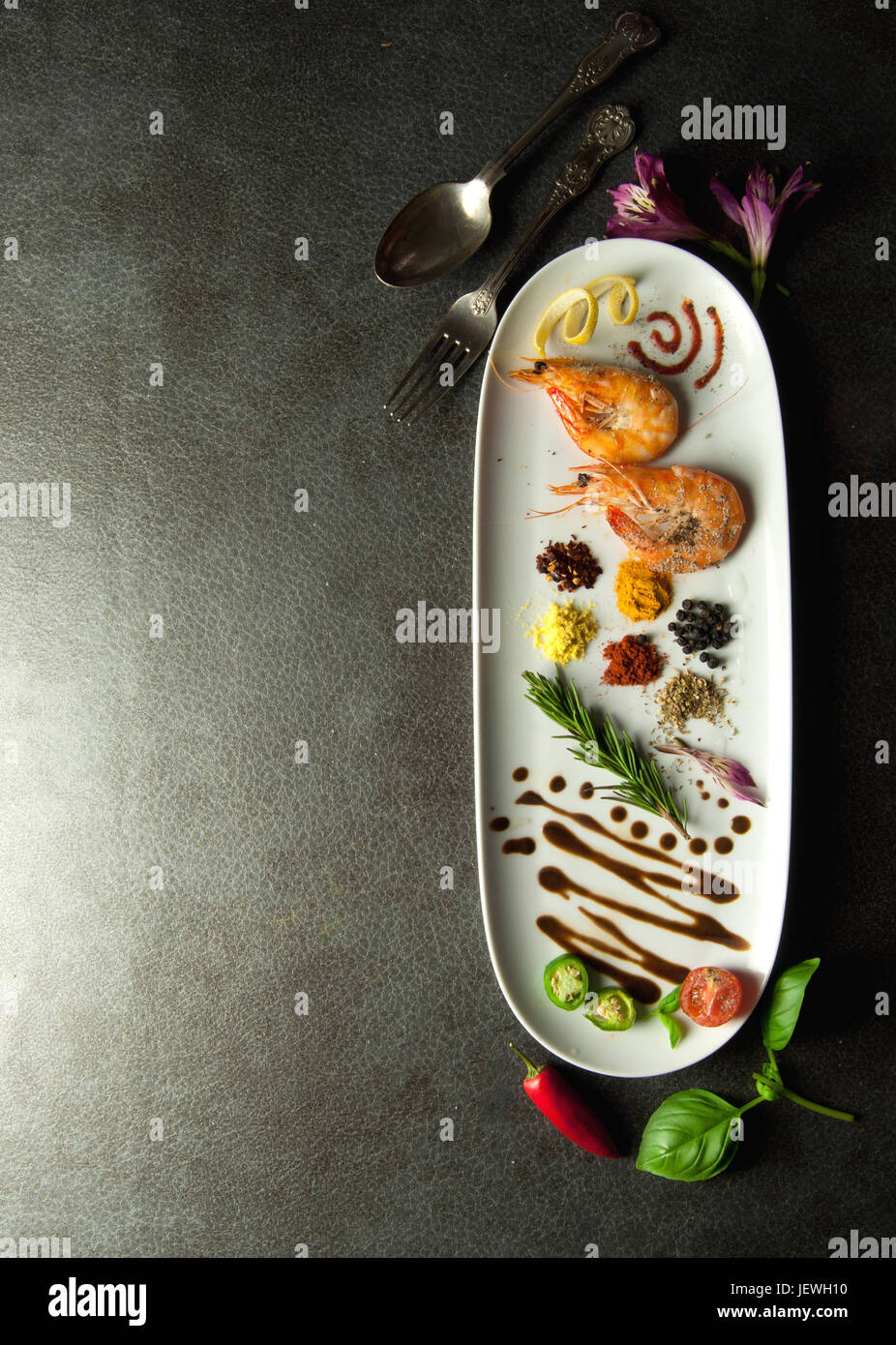 Herbs and spices on a plate with cooked prawns Stock Photo Alamy
