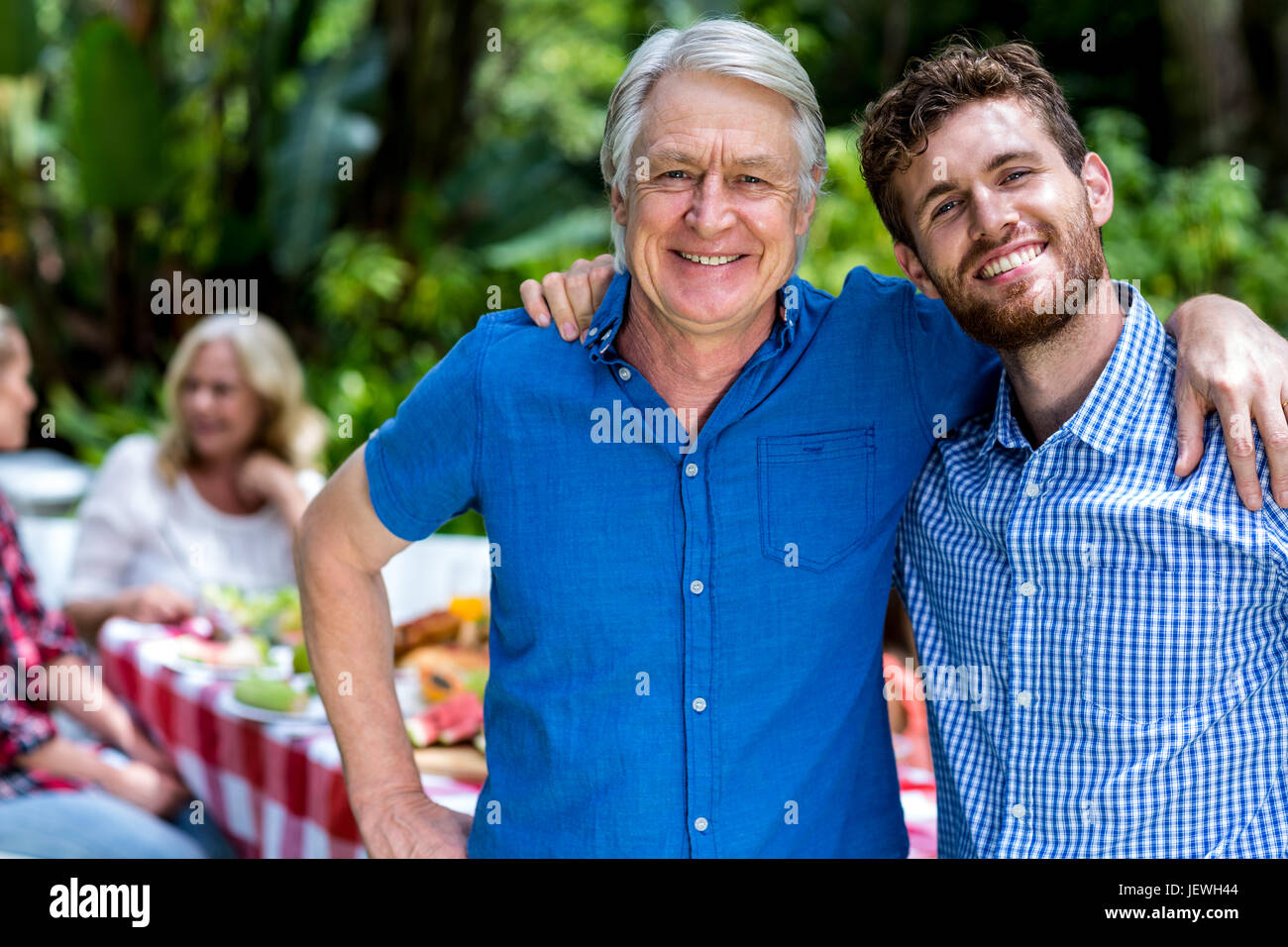 Happy father and son standing in yard Stock Photo