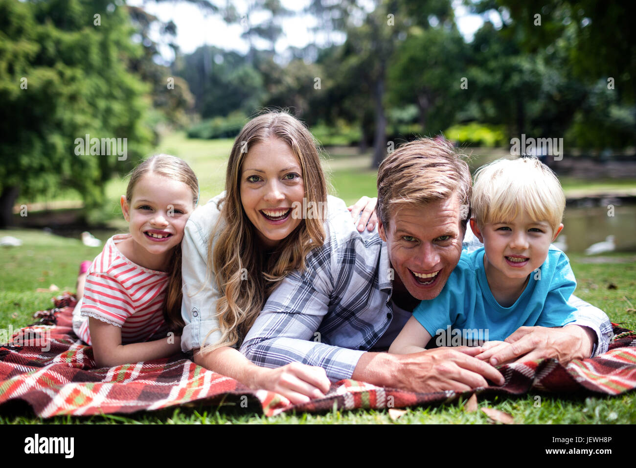 Happy children lying in grass hi-res stock photography and images - Alamy