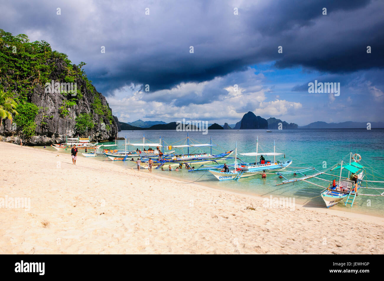 Outrigger boats before a strom anchoring on a sandy beach  in  the Bacuit archipelago, Palawan , Philippines Stock Photo