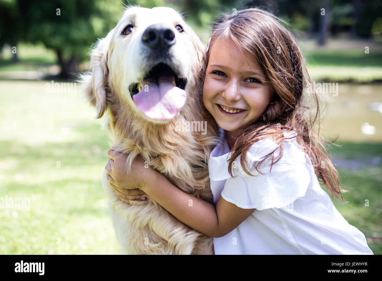 Smiling girl with her pet dog in the park Stock Photo - Alamy