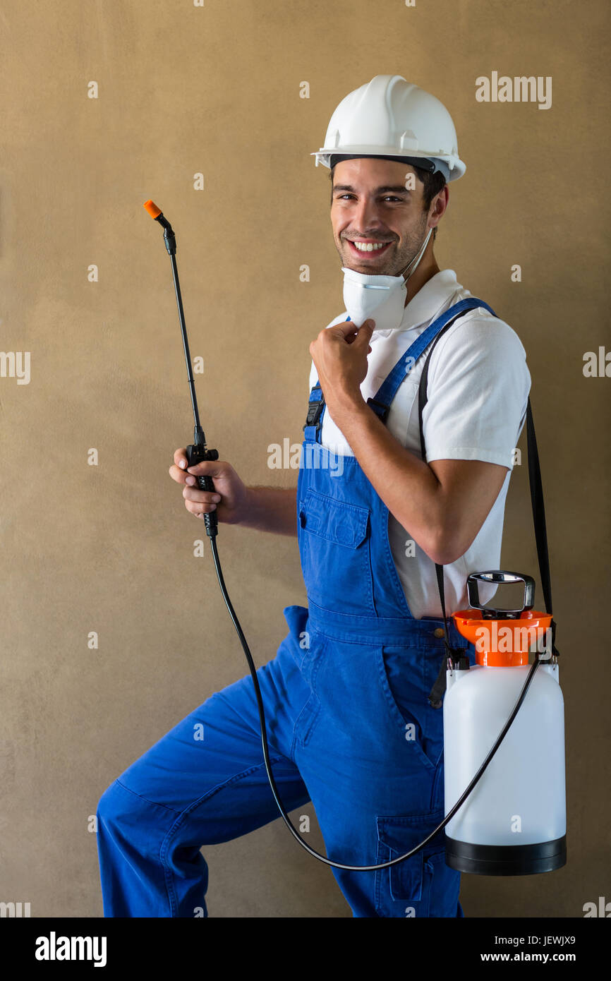 Portrait of happy manual worker with sprayer Stock Photo