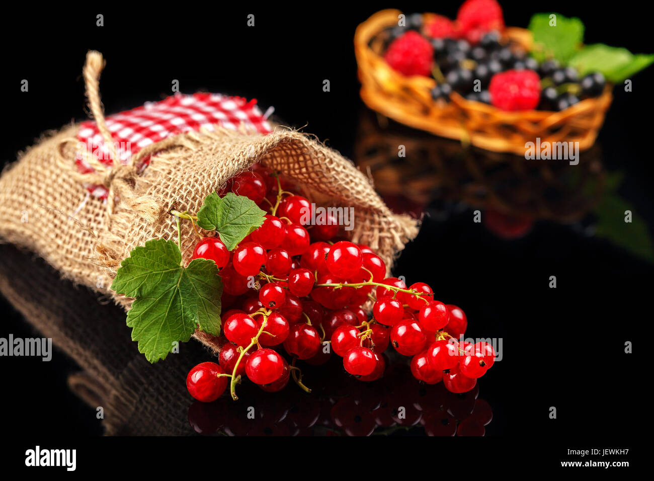 Black and red currants on a dark background, close-up Stock Photo