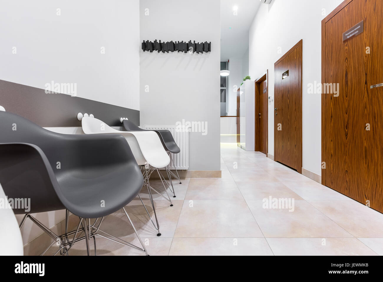 Bright Clinic Waiting Room With Black And White Chairs And