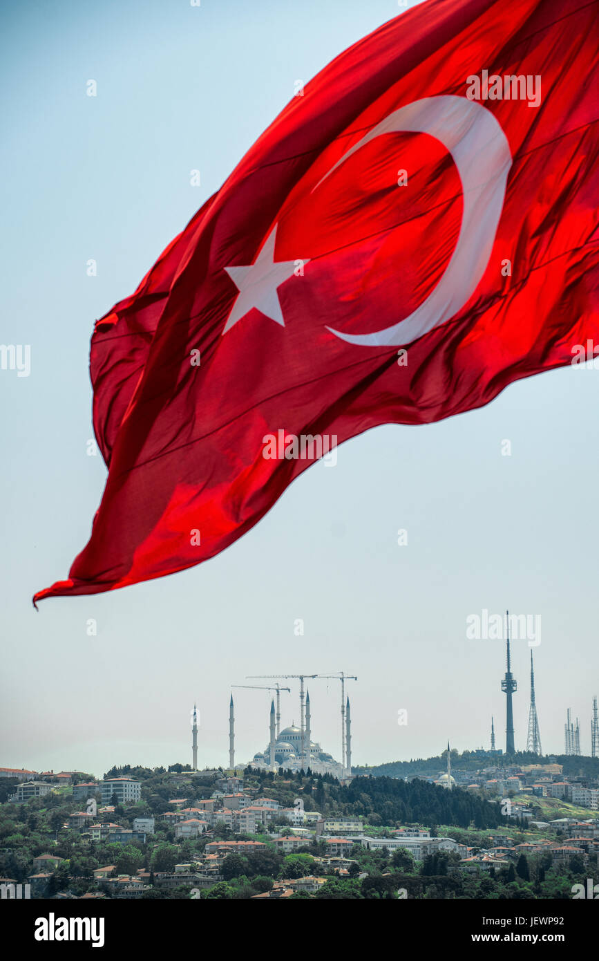 The national flag of Turkey flying over the Çamlıca Mosque under construction in Istanbul. Stock Photo