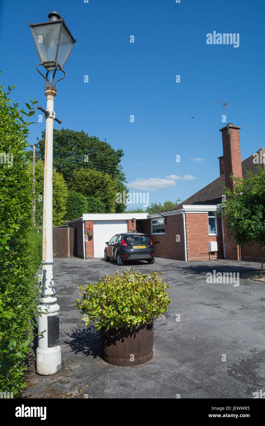 A classic Victorian-style Revo Tipton street light being used as an ornamental feature on a driveway. Stock Photo