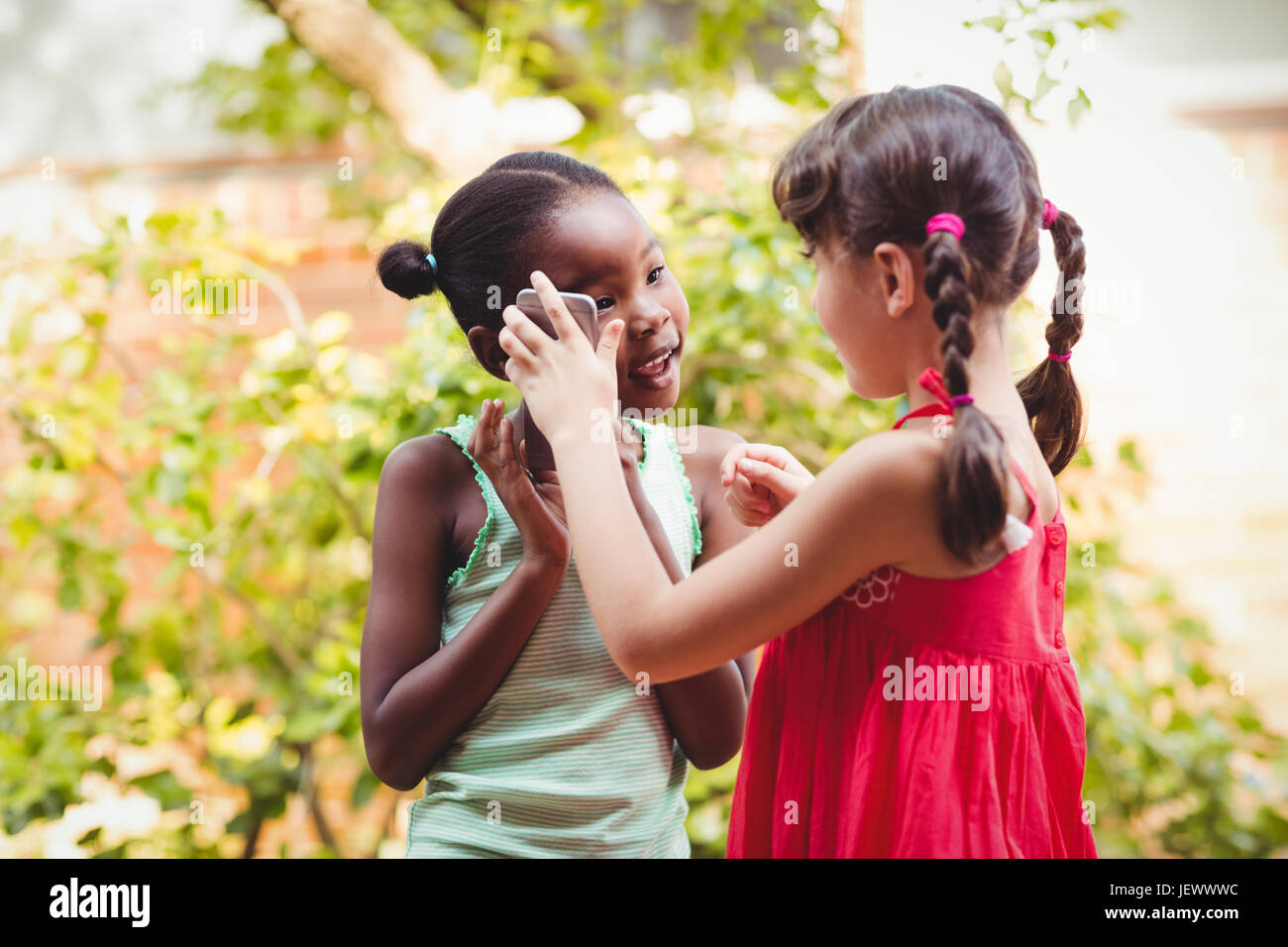 Two girls posing holding hi-res stock photography and images - Alamy
