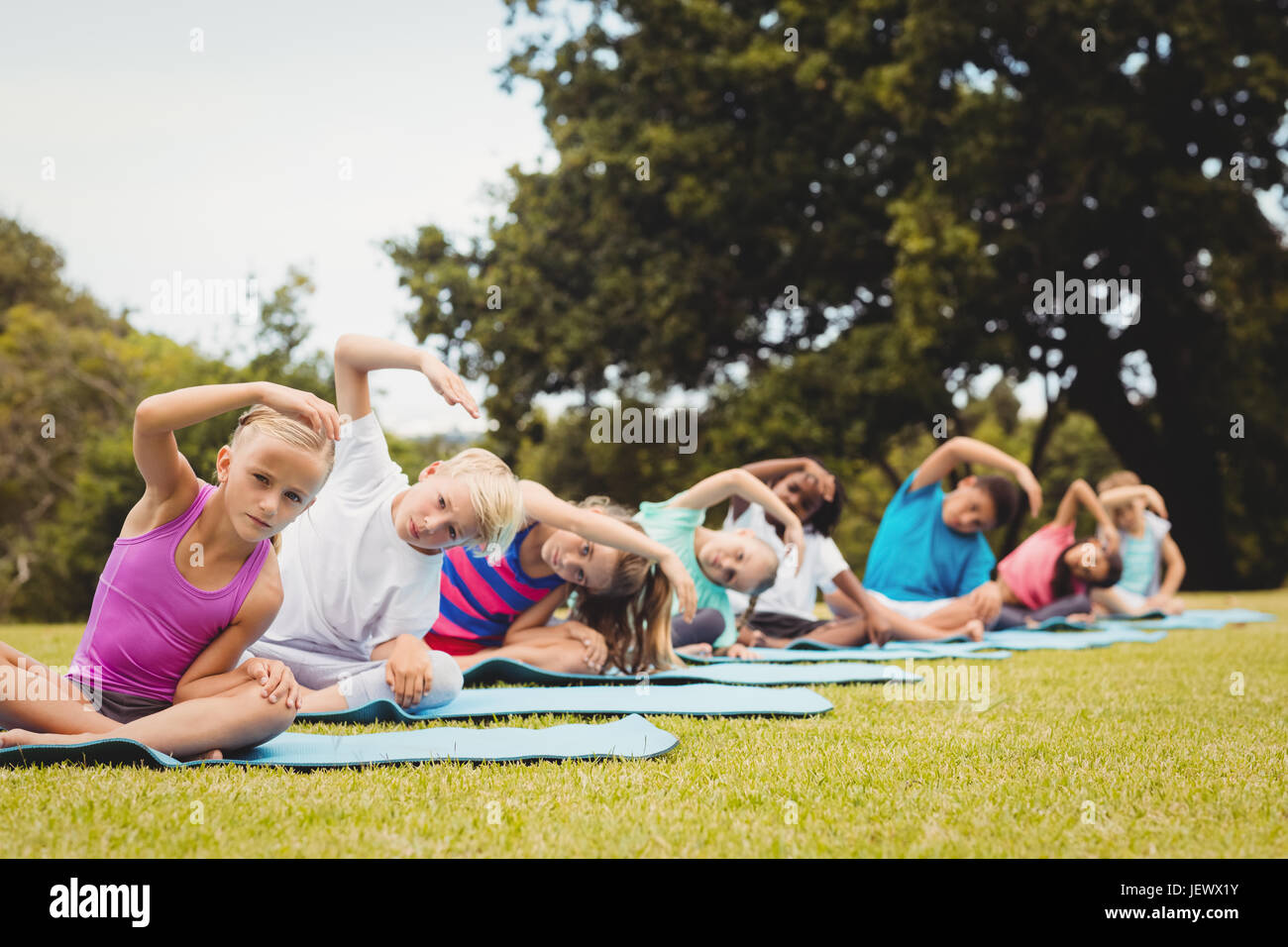 Group of children doing yoga Stock Photo - Alamy