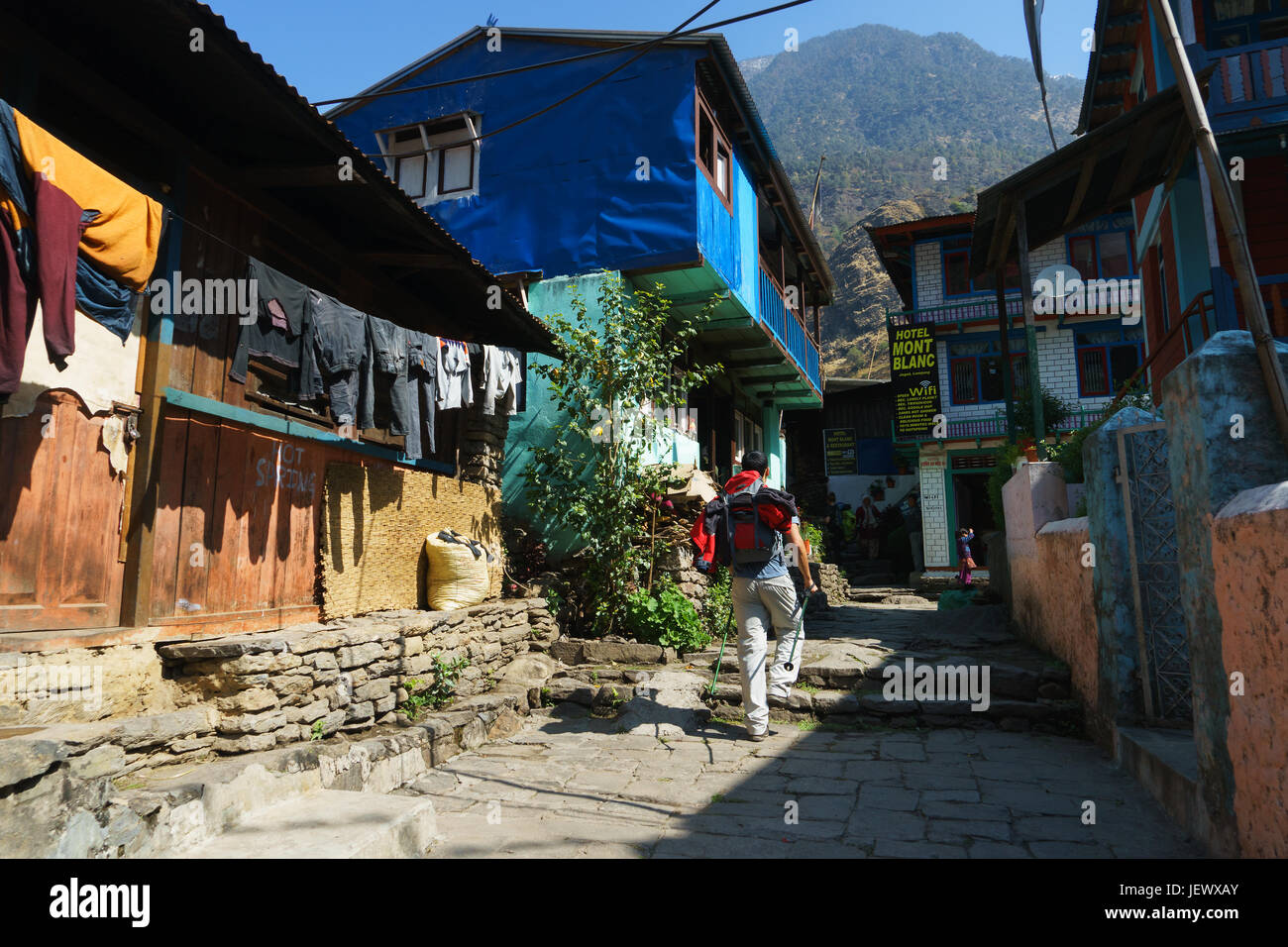 Trekker going through the village of Jagat on the Annapurna circuit, Nepal. Stock Photo