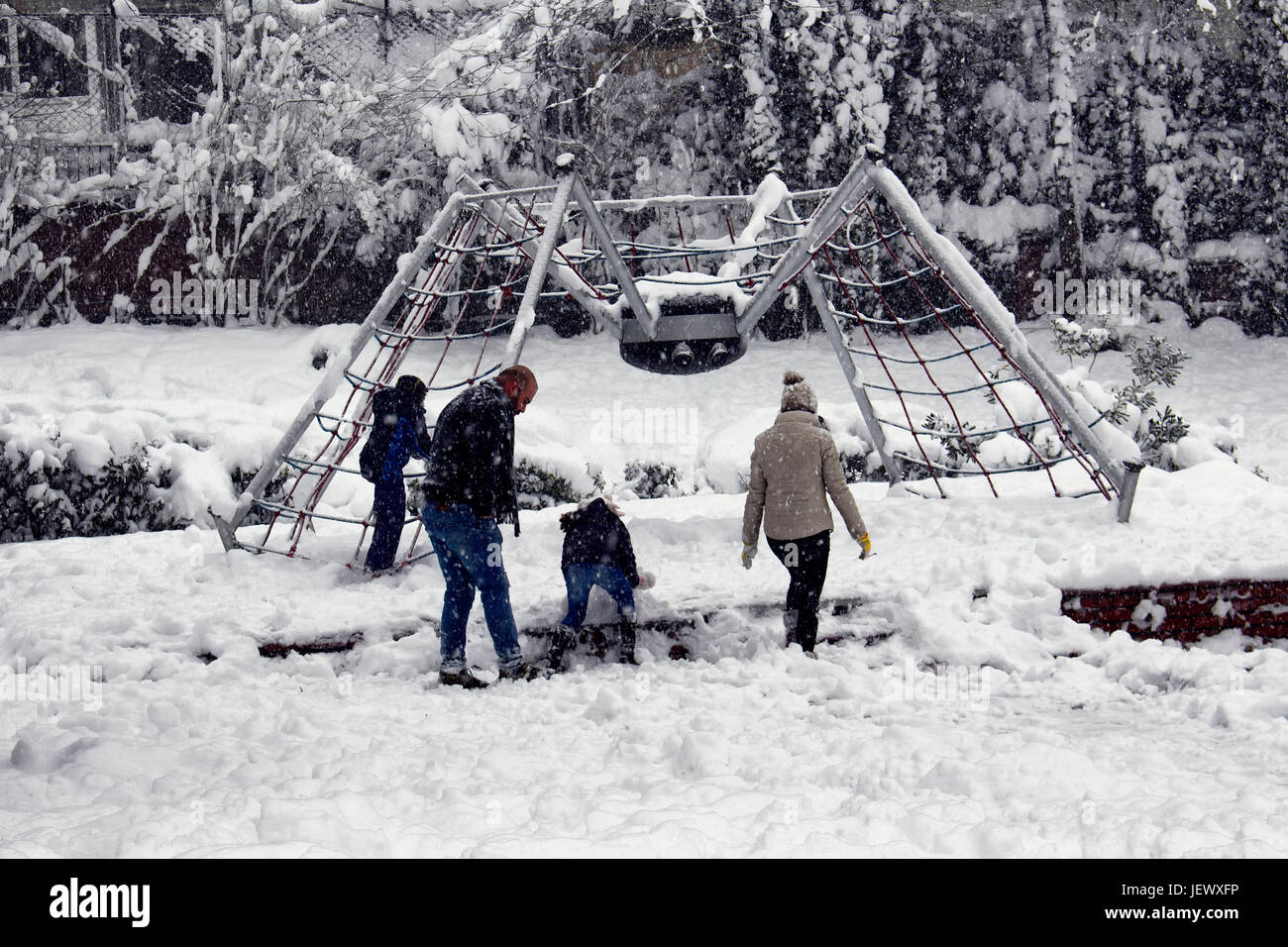 Family with children play and have fun in snow at park called 'Macka Demokrasi - Sanat Parki' in Istanbul Stock Photo