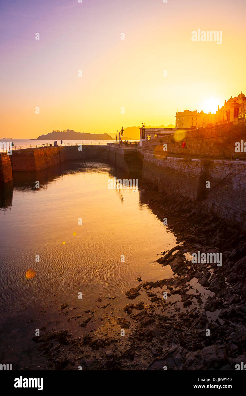 Plymouth waterfront harbour with drakes island in background, golden sunset, Plymouth, Devon, UK, England Stock Photo