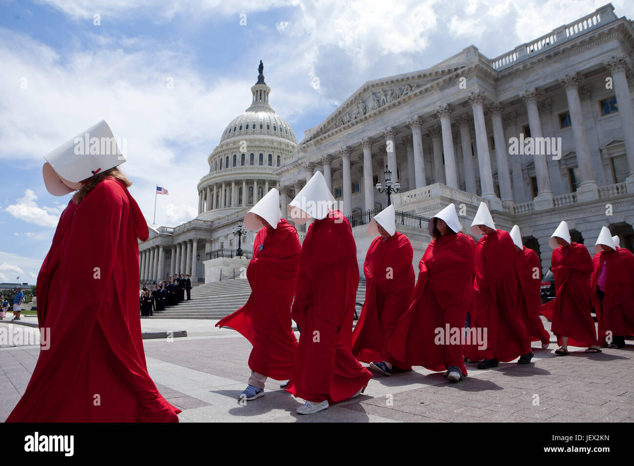 Washington, DC, USA. 27th June, 2017. Ahead of the US Senate AHCA vote (American Health Care Act), hundreds gather on capitol hill to protest Republican provisions related to women's healthcare, including many senators working to delay the vote on Trumpcare. Women dressed in red, inspired by Handmaid's Tale, protest at the US Capitol building. Credit: B Christopher/Alamy Live News Stock Photo