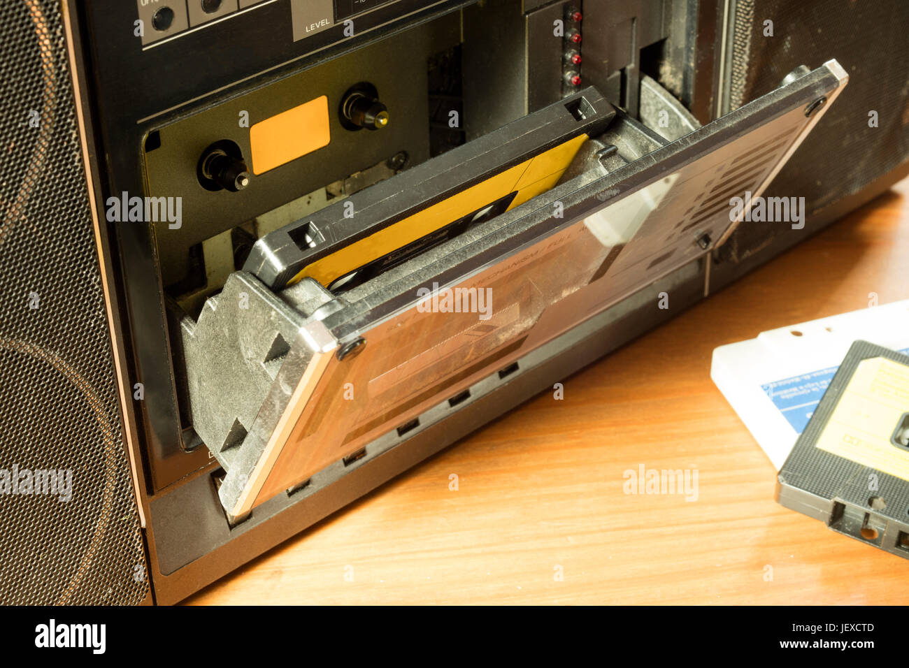 Vintage cassette player with tape inside on a wooden table Stock Photo ...