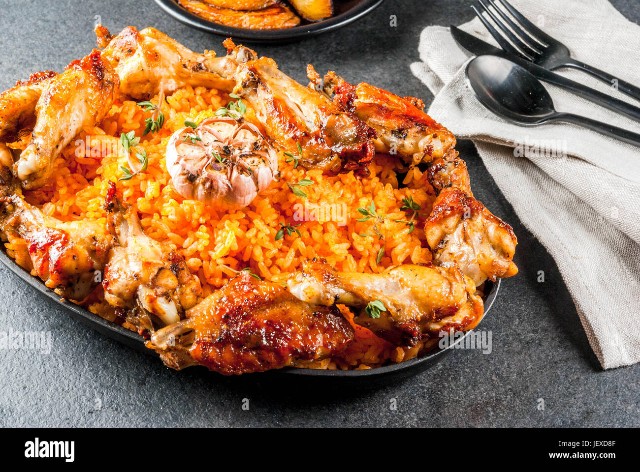 West African national cuisine. Jollof rice with grilled chicken wings