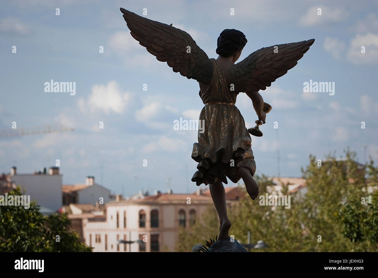 Figure of an angel with wings sculpted in wood with the sacramental cup. Holy week, Spain Stock Photo