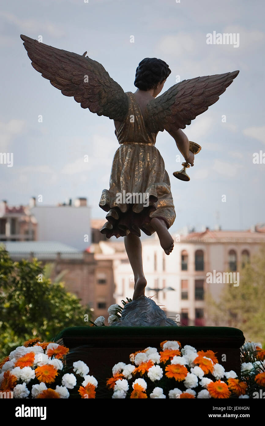 Figure of an angel with wings sculpted in wood with the sacramental cup. Holy week, Spain Stock Photo