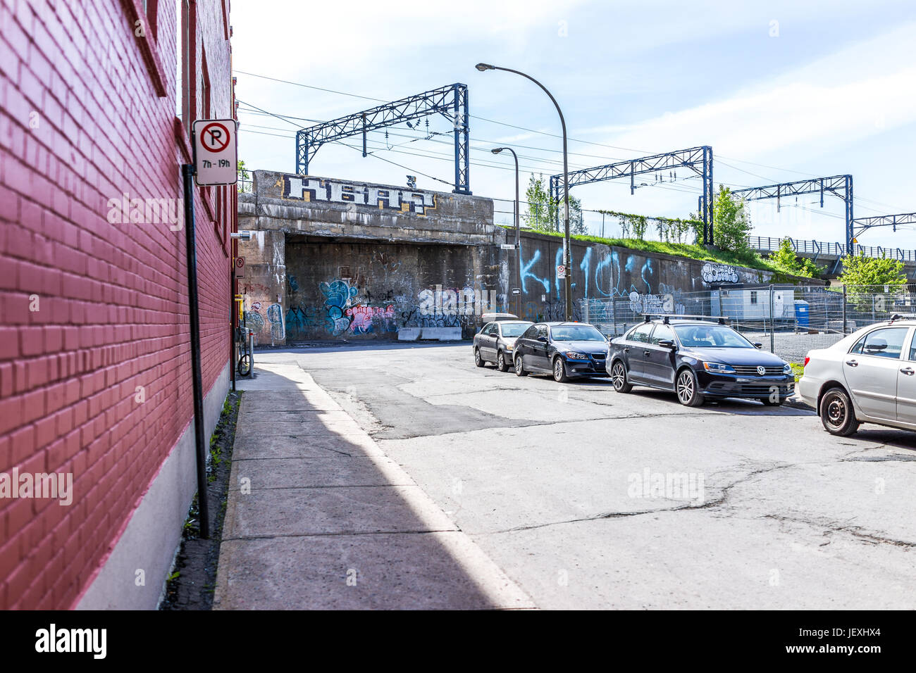 Montreal, Canada May 28, 2017 Downtown area with street parking signs, cars and graffiti