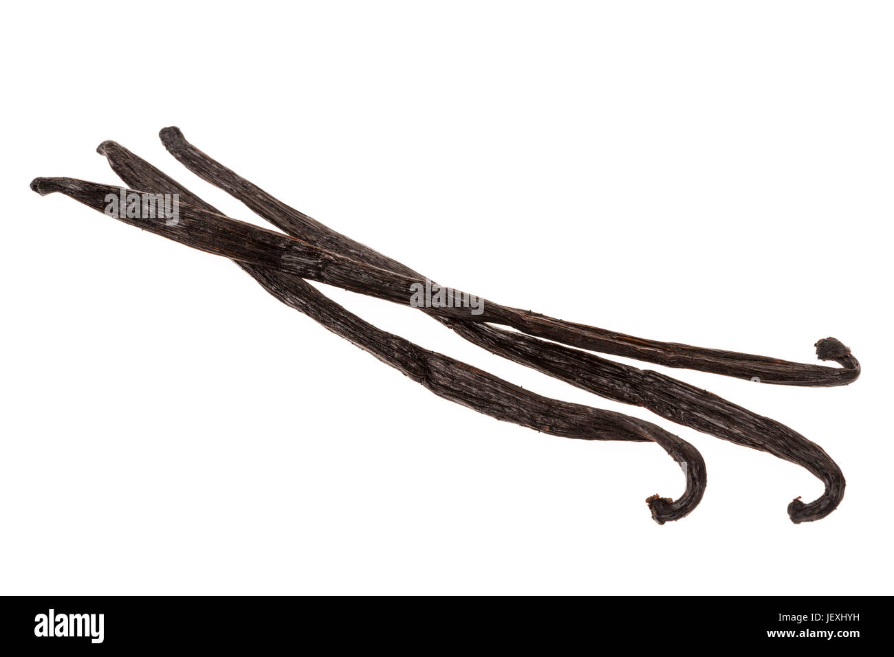 Three whole vanilla bean pods isolated on white background Stock Photo