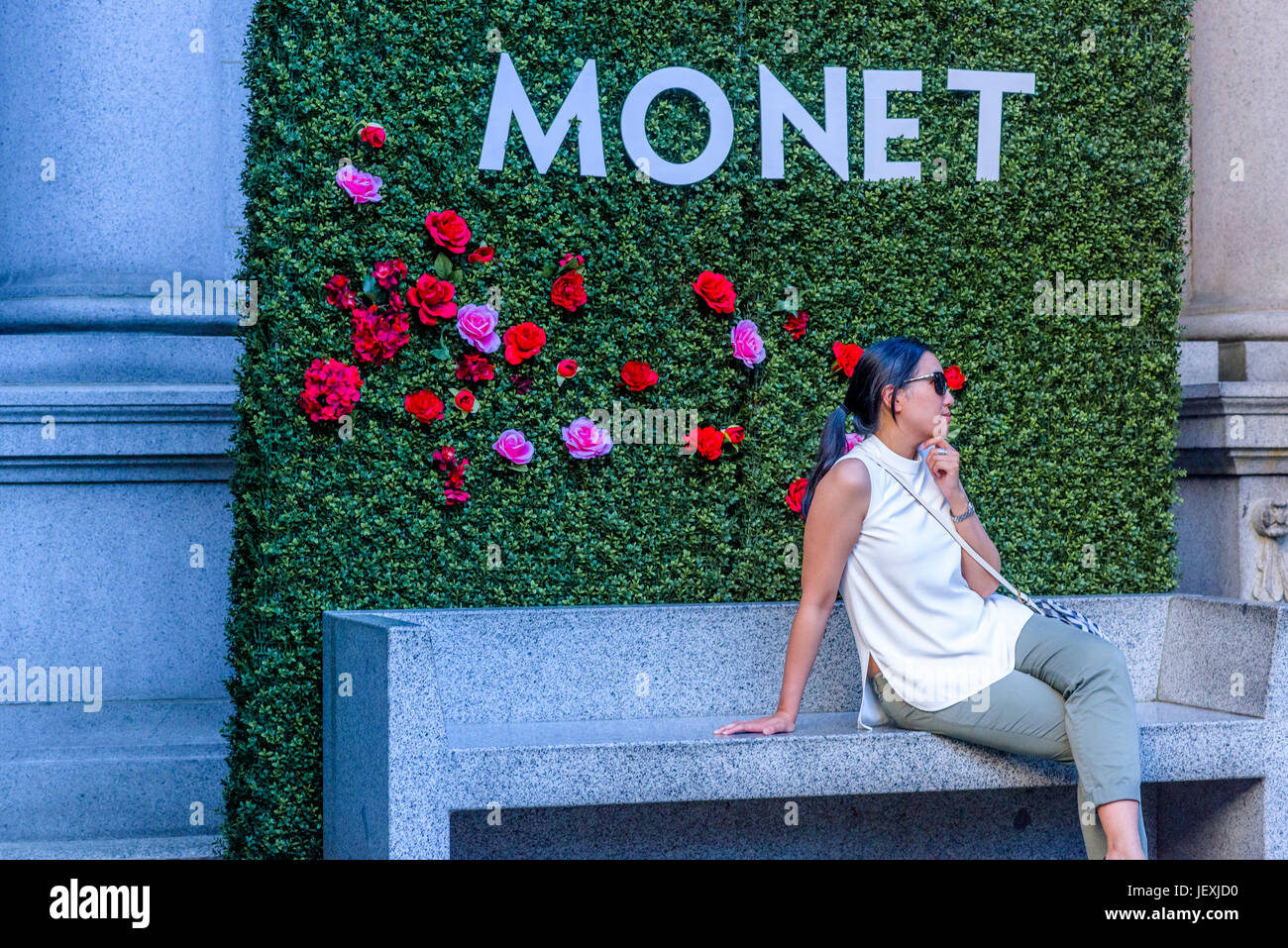 Woman in front of flower wall, outside Vancouver Art Gallery, Vancouver, British Columbia