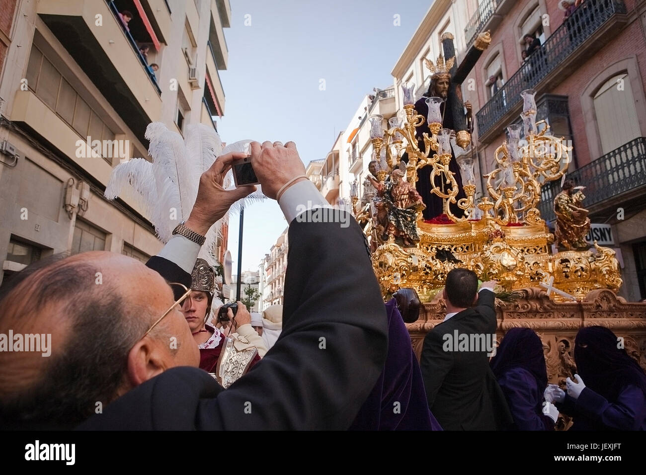 Man taking photographs during a Holy week in the good Friday procession, brotherhood of El Nazareno, Linares, JaŽn province, Andalusia, Stock Photo
