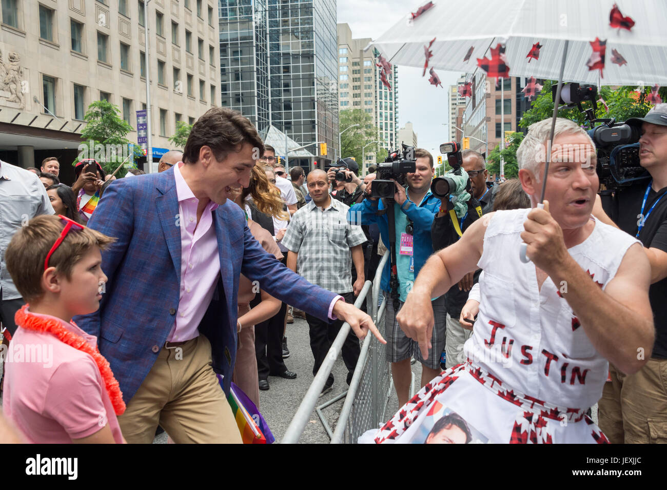 Toronto, Canada. 25 June 2017. Canadian Prime Minister Justin Trudeau greets fan Jamie Godin and looks at his 'Justin' outfit. Stock Photo