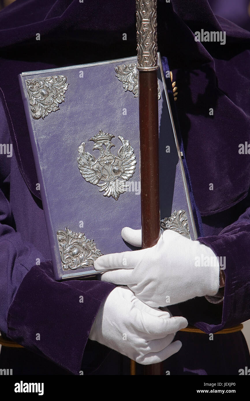 penitent with the rule book governing the brotherhood with velvet caps and appliques of embossed silver, Spain Stock Photo