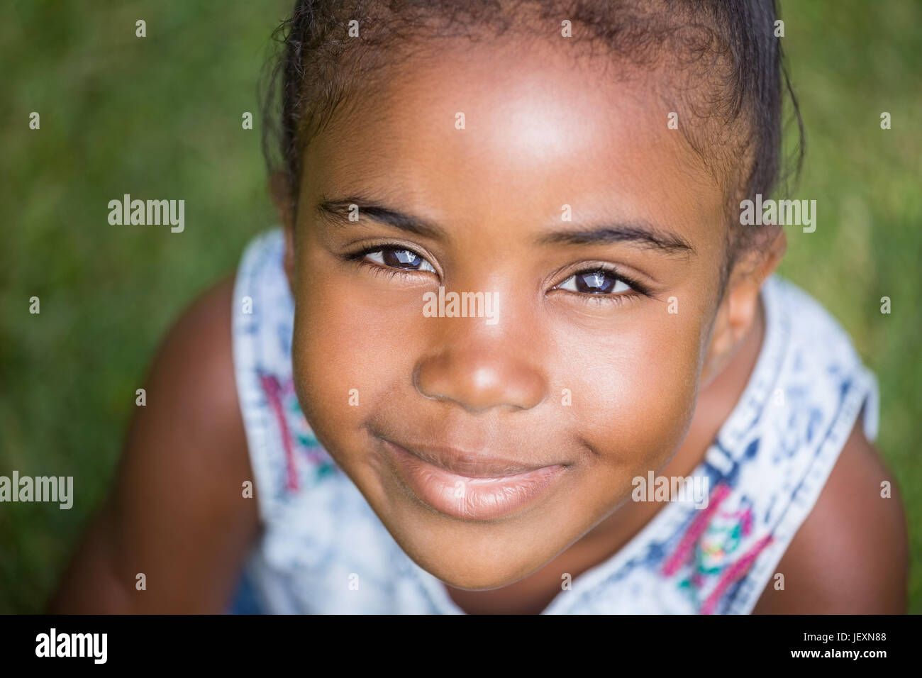 Smiling girl looking at the camera Stock Photo - Alamy