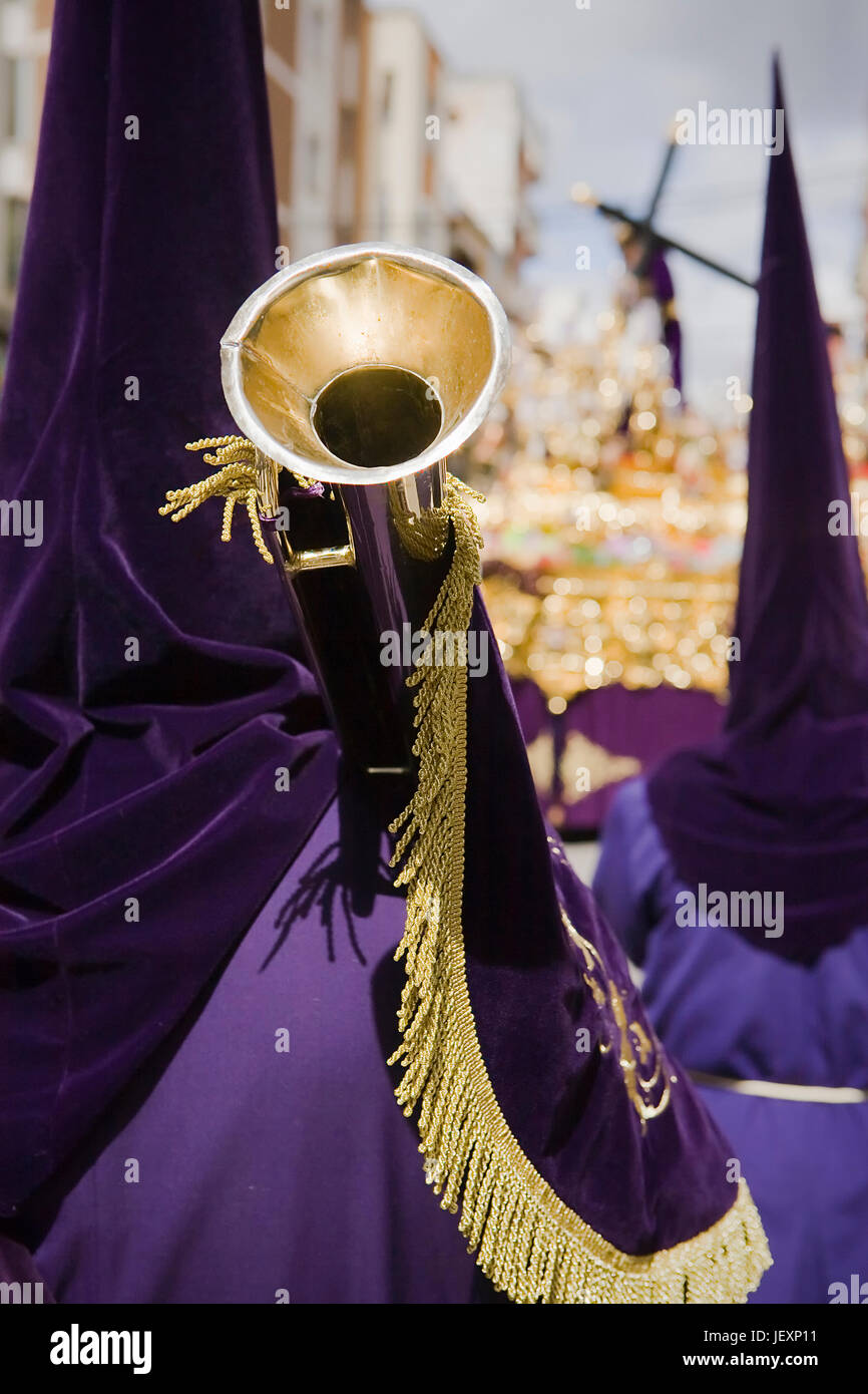 penitent purple tunic holds a trumpet during Holy week procession ...