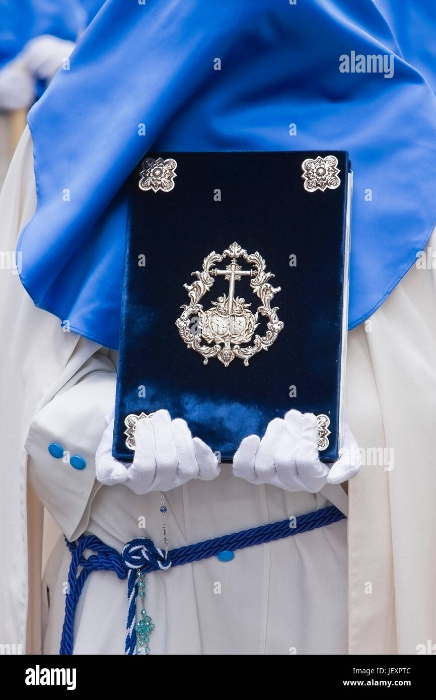 penitent with the rule book governing the brotherhood with velvet caps and appliques of embossed silver, Spain Stock Photo