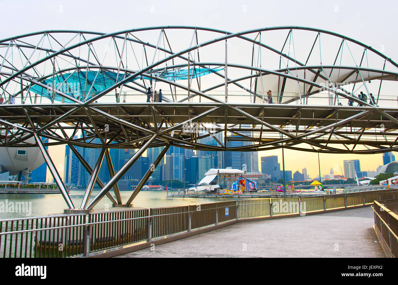 SINGAPORE - JAN 14, 2107: People walking by the Helix Bridge in Singapore. The Helix is fabricated from 650 tonnes of Duplex Stainless Steel and 1000  Stock Photo