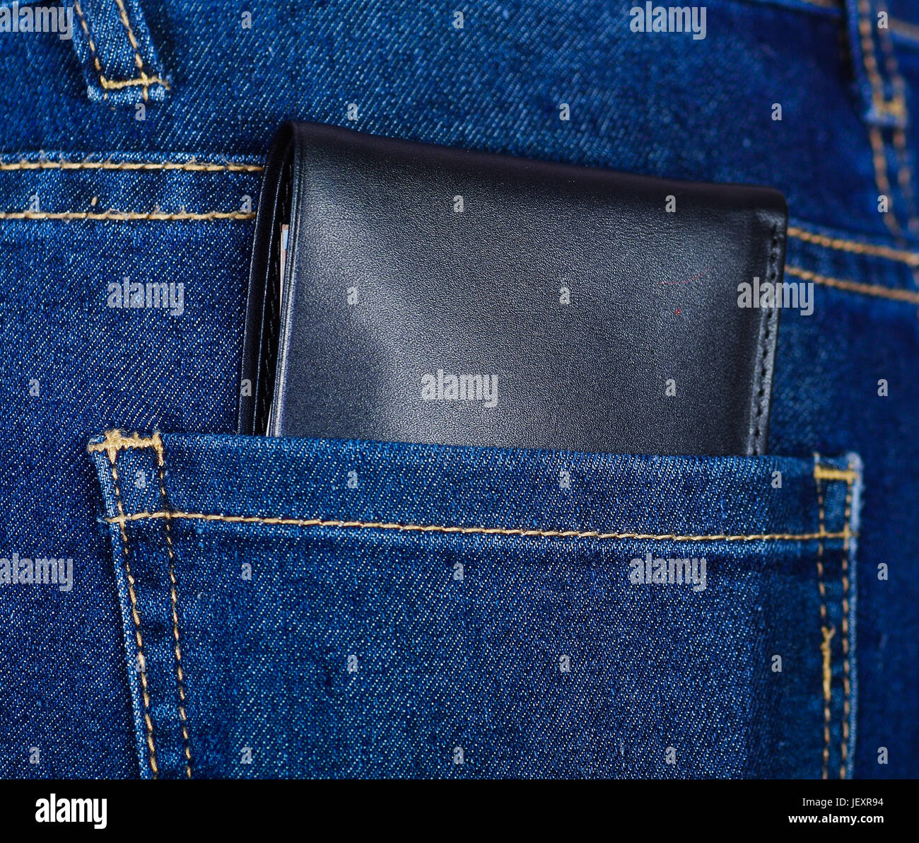 Black wallet inside of jeans back pocket Stock Photo - Alamy