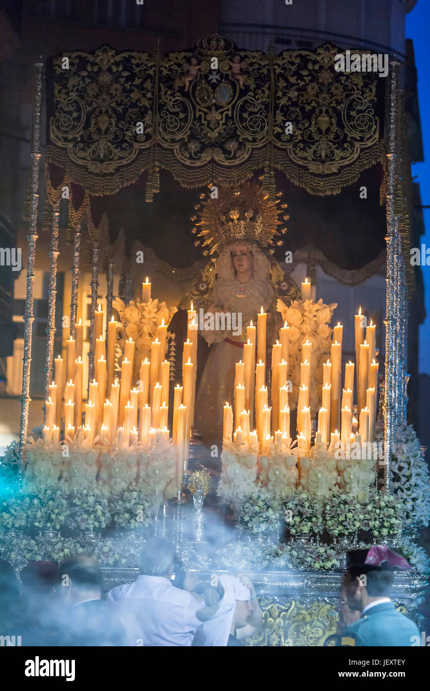 Linares, Jaen province, SPAIN - March 17, 2014: Nuestra Señora del Rosario passing by the church of San Francisco with the candeleria illuminated carr Stock Photo