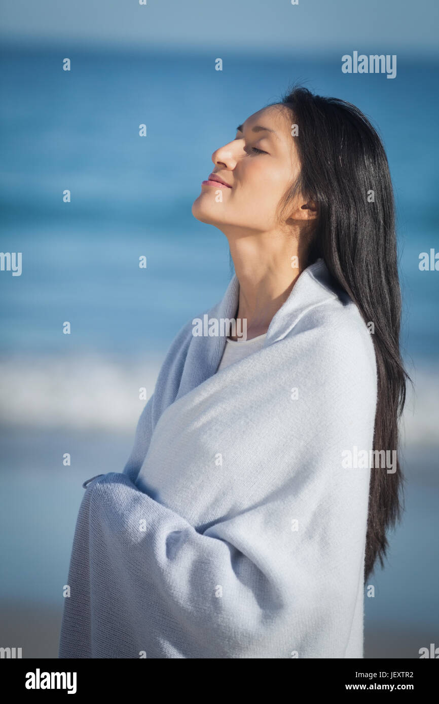 Young woman standing on beach Stock Photo - Alamy