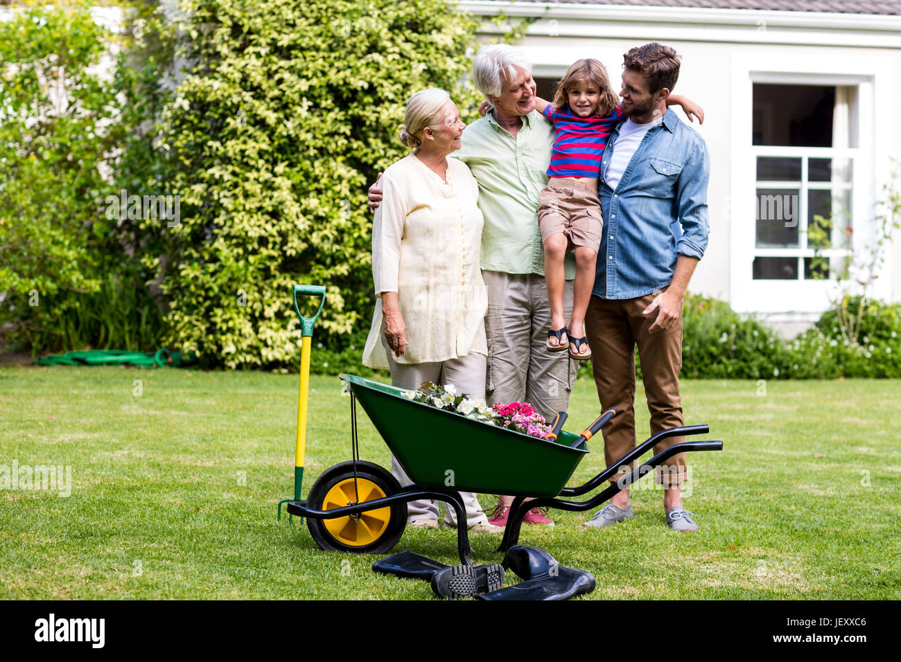 Father and grandfather carrying son at yard Stock Photo - Alamy